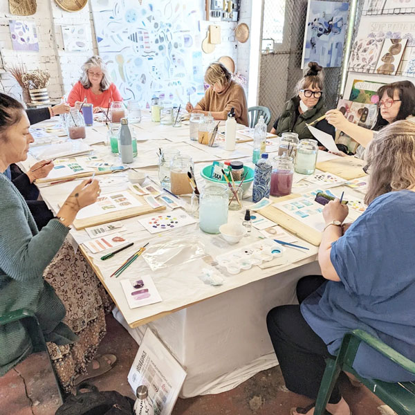 a group of women enjoying an art workshop at the art garden gallery