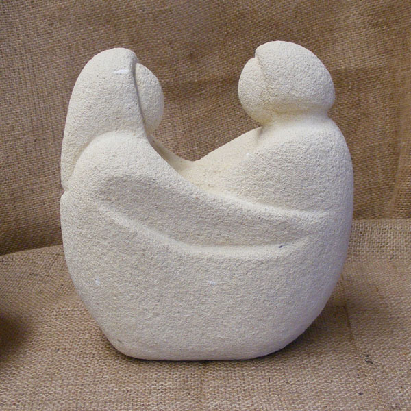a carved concrete statuette of a couple in a boat