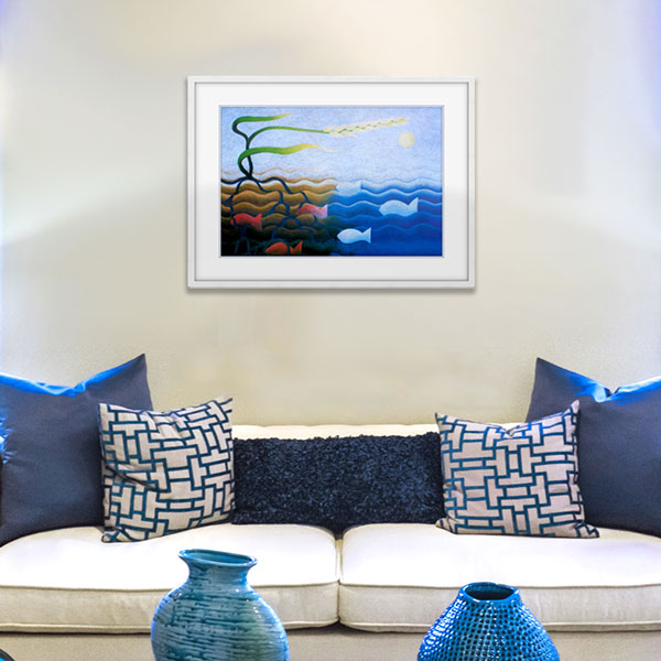 A framed print of fish and wheat in a light white frame styled in a lounge room