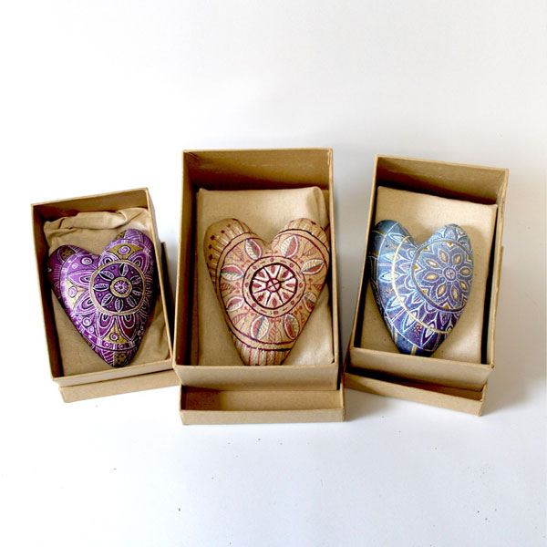 three beautiful painted hearts in boxes