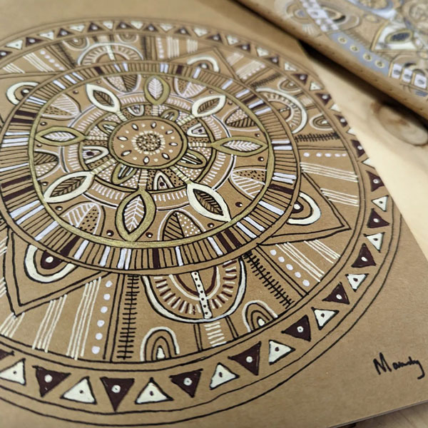 a closeup of the mandala patterned notebook on kraft paper