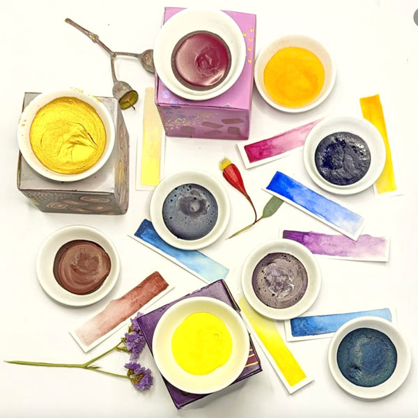 a collection of paint bowls and coloured swatches