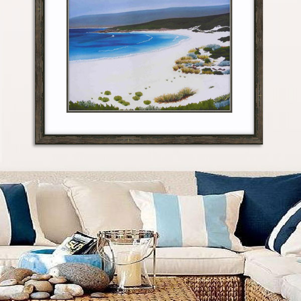 an insitue photograph of the smith beach limited edition framed in natural wood above a light coloured lounge interior