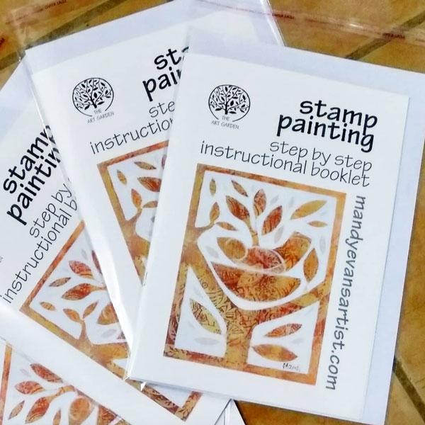 a photo of a group of stamp painting workbooks lying on a table