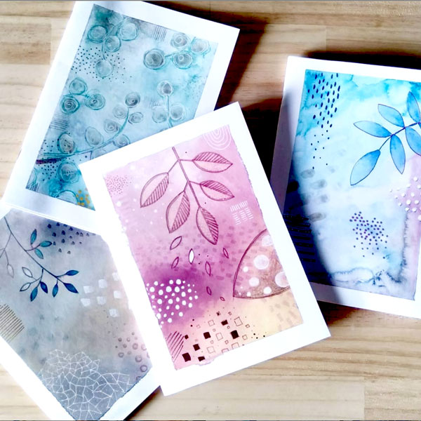 a series of abstract watercolour notebooks in pink and blues